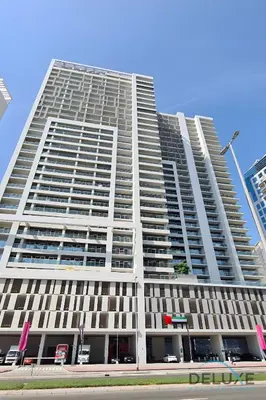 a large building with many windows on a street at Hot Offer Modern 1BR with Scenic Water Canal Views by Deluxe Holiday Homes in Dubai