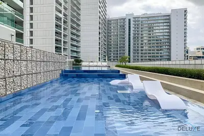 a swimming pool on the roof of a building with buildings at Hot Offer Modern 1BR with Scenic Water Canal Views by Deluxe Holiday Homes in Dubai