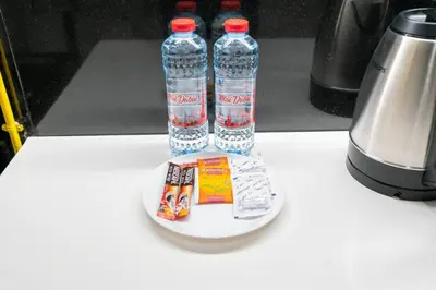 three bottles of water sitting on a plate on a counter at Unique Studio in JVC - Dubai in Dubai