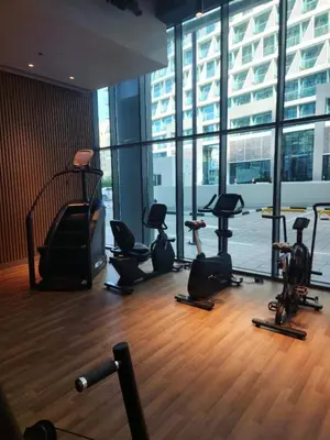 a gym with a bunch of exercise equipment in a building at Modern 1BR Seven Palm Private Beach Infinity Pool in Dubai