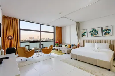 a hotel room with a bed and a large window at Livbnb Seaside Studio in Palm Jumeirah with Private Terrace and Direct Access to Nakheel Mall in Dubai