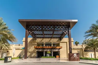 a building with awning and palm trees in front of it at Livbnb Seaside Studio in Palm Jumeirah with Private Terrace and Direct Access to Nakheel Mall in Dubai