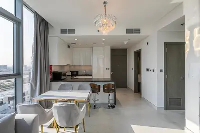 a kitchen and dining room with a table and chairs at Spacious I Burj Khalifa View I District One in Dubai