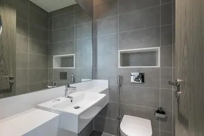 a bathroom with a sink and a toilet at Spacious I Burj Khalifa View I District One in Dubai