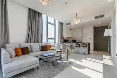 a living room with a couch and a table at Spacious I Burj Khalifa View I District One in Dubai