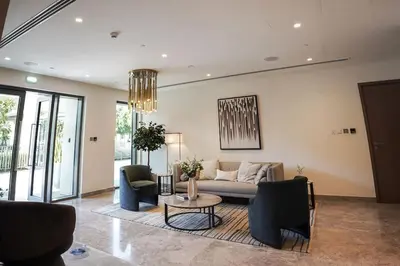 a living room with a couch and chairs and a table at Downtown Luxurious 1BR Near Dubai Mall and Fountain in Dubai
