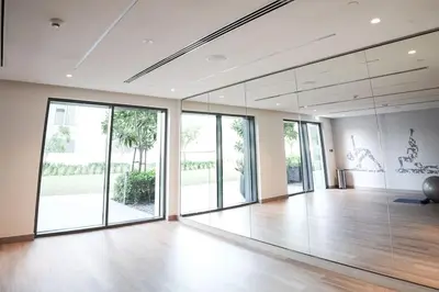 a large room with glass doors and a wooden floor at Downtown Luxurious 1BR Near Dubai Mall and Fountain in Dubai