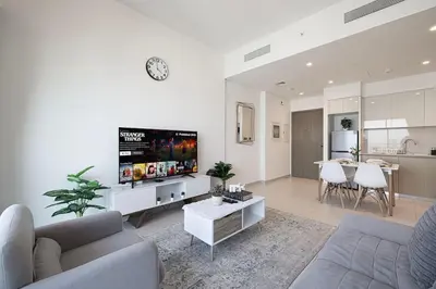 a living room with a couch and a flat screen tv at Downtown Luxurious 1BR Near Dubai Mall and Fountain in Dubai