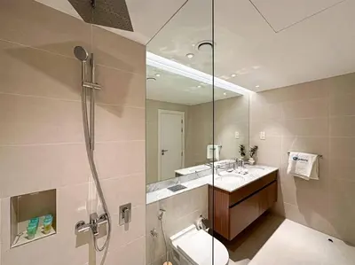 a bathroom with a shower and a sink and a mirror at HiGuests - Family Dream Escape with Private Beach Access in Dubai