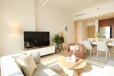 a living room with a couch and a table at HiGuests - Dream Vacation Apartment in La Rive 1 in Dubai