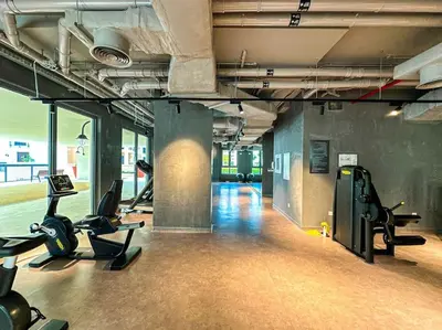 a gym with treadmills and exercise equipment in a building at HiGuests - Dream Vacation Apartment in La Rive 1 in Dubai