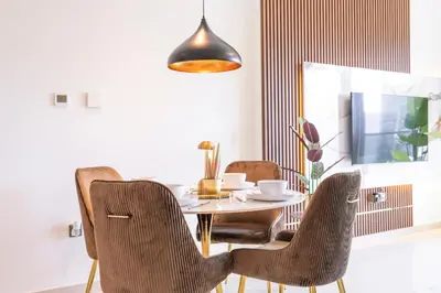 a dining room with a table and two chairs at Chic Lux 2BR I High Floor l by Burj Khalifa & Dubai Mall I Pool l Gym in Dubai