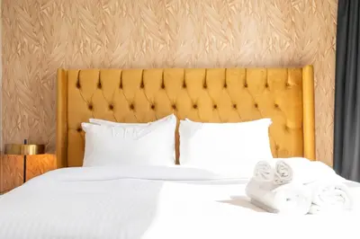 a bedroom with a bed with white sheets and pillows at Chic Lux 2BR I High Floor l by Burj Khalifa & Dubai Mall I Pool l Gym in Dubai