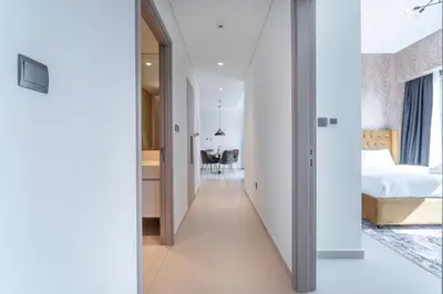 a hallway leading to a bedroom in a house at Chic Lux 2BR I High Floor l by Burj Khalifa & Dubai Mall I Pool l Gym in Dubai