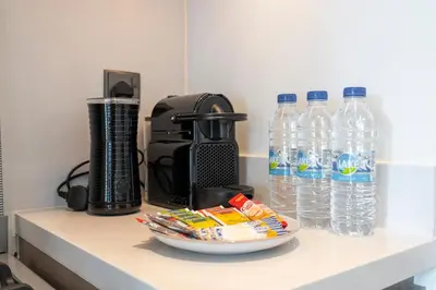 a counter with bottles of water and a plate of snacks at Chic Lux 2BR I High Floor l by Burj Khalifa & Dubai Mall I Pool l Gym in Dubai