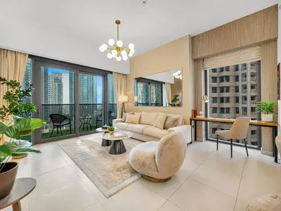a living room with a couch and a table at Luxurious & Spacious 2BR l Burj & Fountain Views l Walk to Dubai Mall l Pool l Gym in Dubai