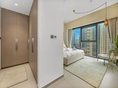 a bedroom with a bed and a large window at Luxurious & Spacious 2BR l Burj & Fountain Views l Walk to Dubai Mall l Pool l Gym in Dubai