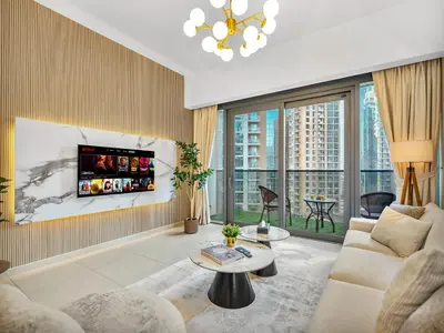 a living room with a couch and a tv at Luxurious & Spacious 2BR l Burj & Fountain Views l Walk to Dubai Mall l Pool l Gym in Dubai