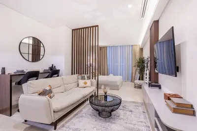 a living room with a white couch and a table at Stylish Studio Walk to Dubai Mall & Burj Khalifa in Dubai