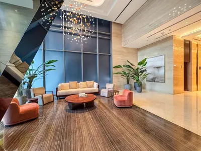 a lobby with couches and chairs and a chandelier at Stylish Studio Walk to Dubai Mall & Burj Khalifa in Dubai
