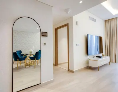 a dining room with a mirror and a table at Elegant 2-BR Gem Quick Access Downtown Dubai in Dubai