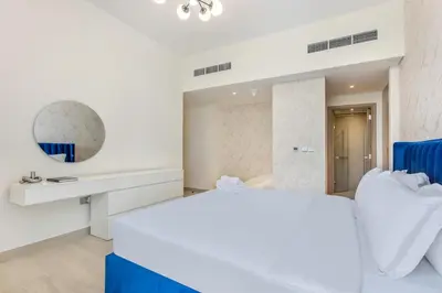 a white bedroom with a white bed and a sink at Elegant 2-BR Gem Quick Access Downtown Dubai in Dubai