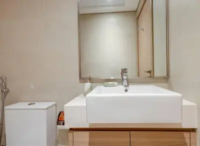 a bathroom with a white sink and a mirror at Elegant 2-BR Gem Quick Access Downtown Dubai in Dubai