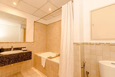 a bathroom with a tub and a toilet and a sink at GMA Rimal5 4BR Sea View in Dubai