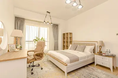 a bedroom with a bed and a desk and a chair at GMA Rimal5 4BR Sea View in Dubai