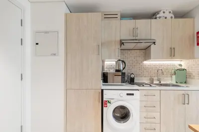 a kitchen with a washer and a washing machine at Fully-equipped studio Palm Jumeirah, Seven in Dubai