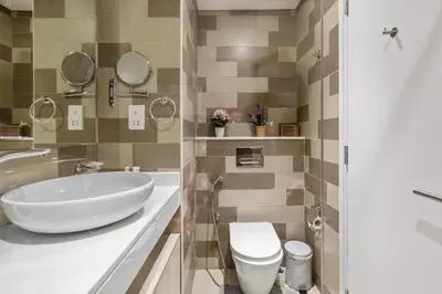 a bathroom with a white sink and a toilet at Fully-equipped studio Palm Jumeirah, Seven in Dubai