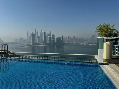 a swimming pool with a view of the city at Fully-equipped studio Palm Jumeirah, Seven in Dubai