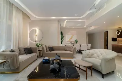 a living room with couches and a dining room at USMANS 4BDRM APARTMENT SEA VIEW Direct BEACH Access Fully Serviced JBR in Dubai