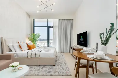 a living room with a couch and a table at ON OFF HH-Meydan One- Cozy STUDIO - Burj Khalifa & Lagoon view in Dubai