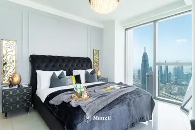 a bedroom with a large bed with a large window at Manzil - 3BR in Boulevard Point connected to Dubai Mall with Incredible View of Burj Khalifa in Dubai