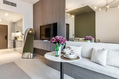 a living room with a couch and a table at The Smart Concierge - Binghatti Canal in Dubai
