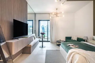a living room with a television and a couch at The Smart Concierge - Binghatti Canal in Dubai