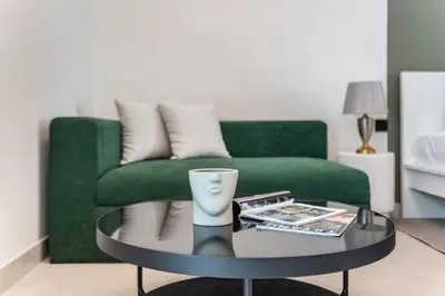 a living room with a green couch and a coffee table at The Smart Concierge - Binghatti Canal in Dubai