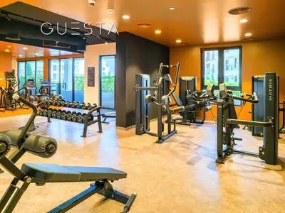 a gym with several treadmills and cardio machines at La Voile by Merass, La Mer Dubai in Dubai