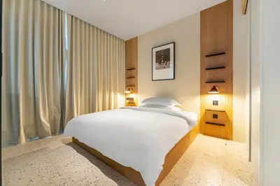 a bedroom with a large white bed and a window at FAM Living - Upside Living - WFH Friendly-Business Bay in Dubai