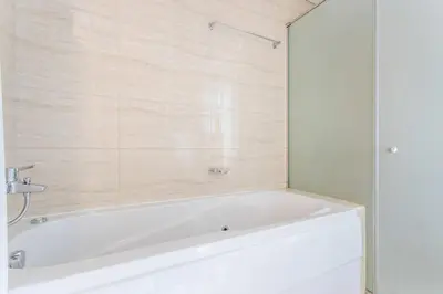 a white bath tub in a bathroom at Frank Porter - Ocean Heights in Dubai