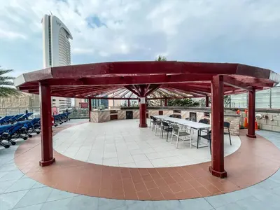 a pavilion with a table and chairs on a building at Frank Porter - Ocean Heights in Dubai