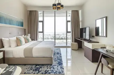 a bedroom with a bed and a desk and a television at Frank Porter - Avanti Tower in Dubai