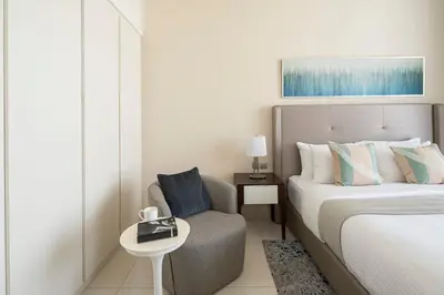 a hotel room with a bed and a chair at Frank Porter - Avanti Tower in Dubai