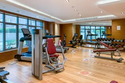 a gym with several treadmills and exercise bikes at Frank Porter - Avanti Tower in Dubai