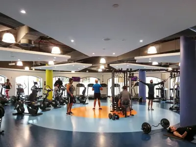 a group of people exercising in a gym at GuestReady - Beachside Escape near Marina Beach in Dubai