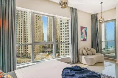 a bedroom with a large window with a view of buildings at Iolanda Home in Dubai