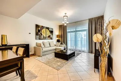 a living room with a couch and a table at Stunning 1BD Marina view apartment in Dubai Marina in Dubai
