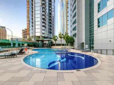 a pool in the middle of a city with tall buildings at Stunning 1BD Marina view apartment in Dubai Marina in Dubai