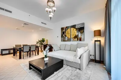 a living room with a couch and a table at Stunning 1BD Marina view apartment in Dubai Marina in Dubai